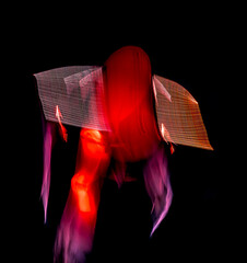 Long exposure of brightly lit objects floating in the night sky