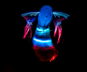 Long exposure of brightly lit objects floating in the night sky