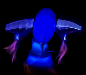 Long exposure of brightly lit objects floating in the night sky