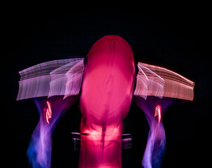 Long exposure of brightly lit objects floating in the night sky