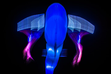 Long exposure of brightly lit objects floating in the night sky