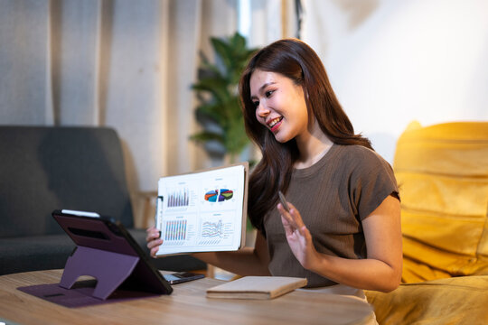 Young woman presenting data chart during online video call