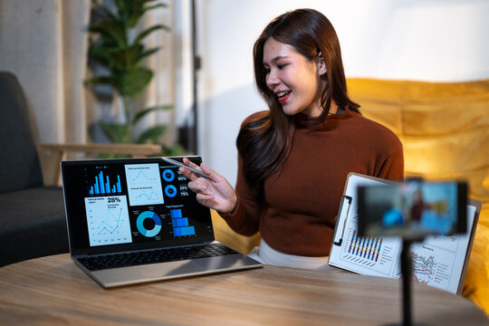 Woman presenting business data charts on laptop during video call