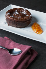 Delectable chocolate lava cake on a plate, served with a fruit topping