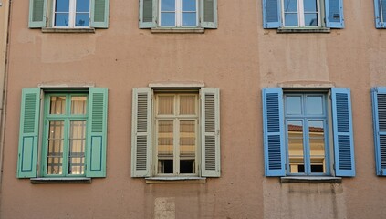 Obraz premium Old building exterior with a colorful modern window design at sunset, travel postcard style