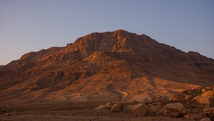 Naklejka premium Dawn breaks over a stunning mountain linked to ancient biblical tales and the Ten Commandments.
