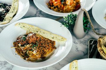 Delicious spaghetti with meatballs on a white plate, ready to be served and enjoyed