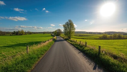 Obraz premium Aerial perspective of a roadway surrounded by rural farmland