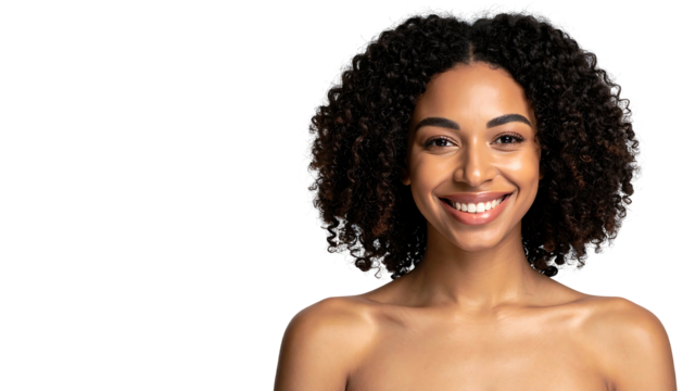 Smiling woman with dark curly hair, bare shoulders, and radiant skin, against a black background