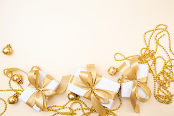 Luxury Christmas and New Year background with gifts, golden ribbons and ornaments. Elegant minimal composition with copy space.