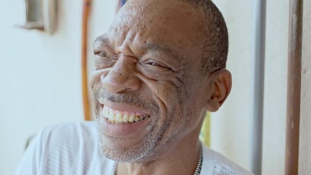 Close-Up Of Older Man Smiling Joyfully With Visible Laugh Lines, Looking Away And Enjoying Cheerful Moment Outdoors