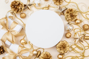 Round white board with golden Christmas decorations and gift boxes. Flat lay with copy space for text or logo.