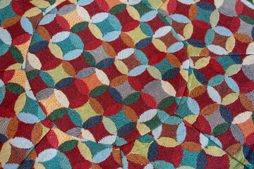 Colorful geometric pattern with overlapping circles in red, blue, green, and yellow hues, creating...