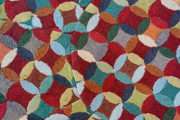 Colorful geometric pattern with overlapping circles in red, blue, yellow, and green, creating vibrant textile design