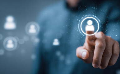 Focused businessman pointing finger at glowing digital icon on virtual screen. modern concept for human resource management, recruitment, customer networking, and targeting