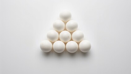 Fresh free-range eggs with white shells on a plain white surface