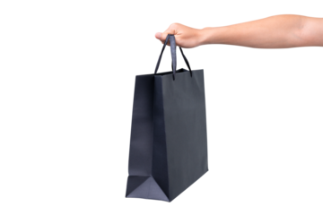 Hand holding black shopping bag isolated on transparent background