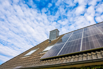 Fototapeta premium Solar panels generating clean energy on residential roof