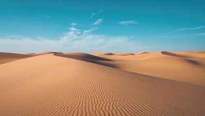 Golden sand hills beneath a clear azure sky
