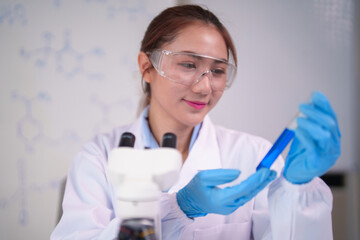 Asian adult scientist conducts laboratory research analysis exploring scientific solutions in modern medical biotech facility