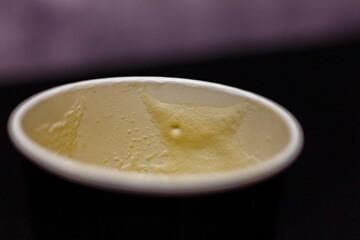 An empty coffee cup with a delicate foam left after a warm morning drink