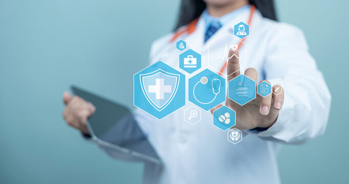 Female doctor in white coat hands touching digital medical interface with health icons, stethoscope, pills and heartbeat symbol, representing health checkup, health insurance and modern healthcare sys