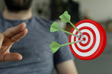 Image depicting darts hitting a bullseye on a dartboard, symbolizing success, achievement, and...