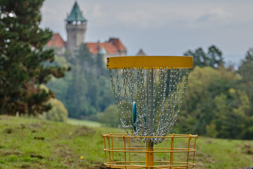 Disc Golf disc in the chain in the basket near the castle