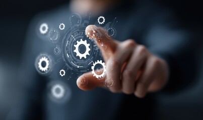 A person's finger touches a glowing digital interface with interconnected gears and circular designs