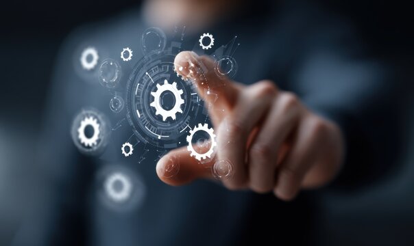 A person's finger touches a glowing digital interface with interconnected gears and circular designs
