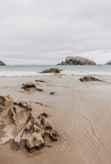 Moody and rocky beach landscape, neutral and desaturated aesthetic palette, with copy space