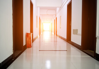A long hotel corridor perspective with doors.