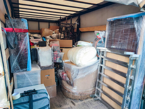 Moving truck interior with furniture and boxes prepared for transport