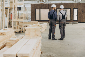 Fototapeta premium Construction workers discussing building project in modular building industry