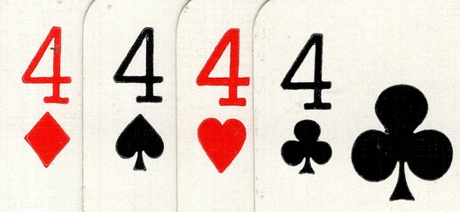 Close up detail of four playing cards of the same value.