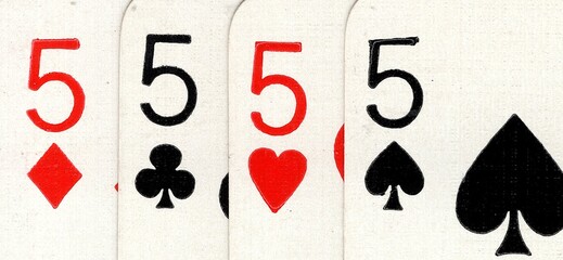 Close up detail of four playing cards of the same value.