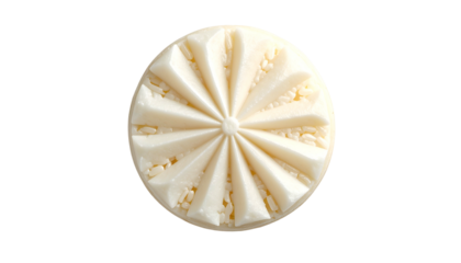Overhead view of a white, round treat with textured, ray-like design on a black background