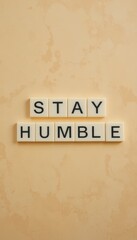 Obraz premium Stay Humble Motivational Quote in Simple Tile Design on Wall