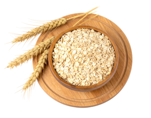 Oats in a wooden bowl with wheat stalks, arranged on a round, light-colored wooden board against a black background