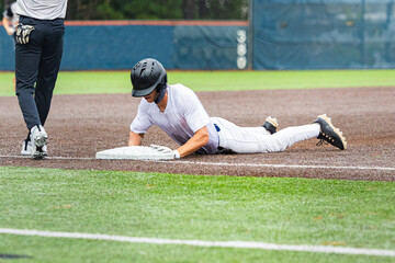 Baseball Player Sliding Headfirst into Third Base
