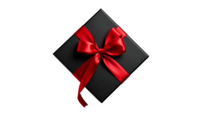 Overhead shot of a square black gift box tied with a vibrant red satin bow, isolated on black