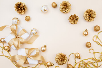 Christmas and New Year background with gift boxes, golden ribbons and decorations. Minimal festive composition with copy space for text or design.