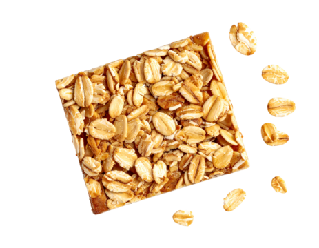 Square granola bar with loose oats scattering around it on a black background, top-down, close-up shot