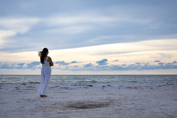 Lonely woman standing by the shore