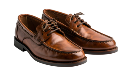Pair of brown leather boat shoes, laces tied, resting on a dark background