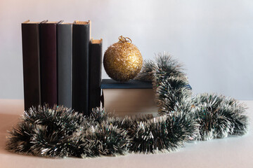On the table are books, Christmas balls and decorations. Horizontal shot.
