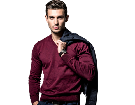 Handsome man wearing a v-neck burgundy sweater glances over shoulder, jacket draped. Background is black