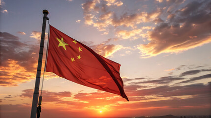 Chinese flag waving in the wind against a beautiful sunset sky