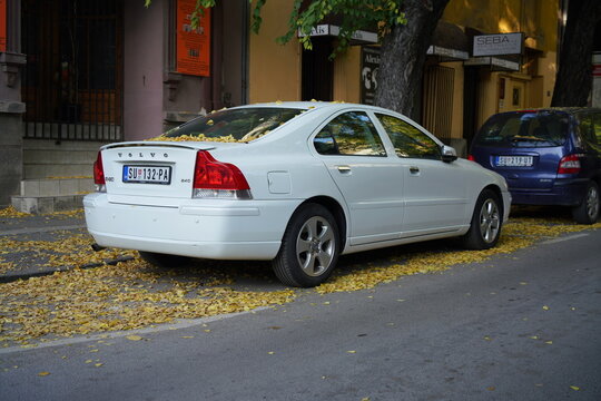 White Volvo S60 first-generation (P24, facelift) sedan is parked on a street. The design highlights the car's distinctive, sleek rear end and aerodynamic silhouette. Subotica, Serbia October 23, 2024