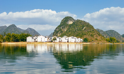 Fototapeta premium Quyang Lake (Quyanghu) karst peaks landscape reflection in water in Baise city, Guangxi province, China